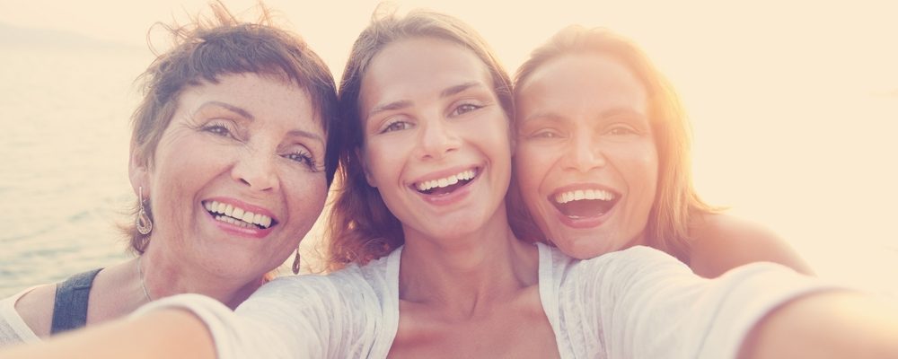 Three woman smiling at the camera