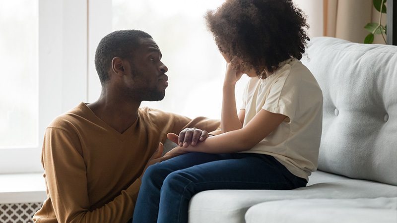 A man consoling a child